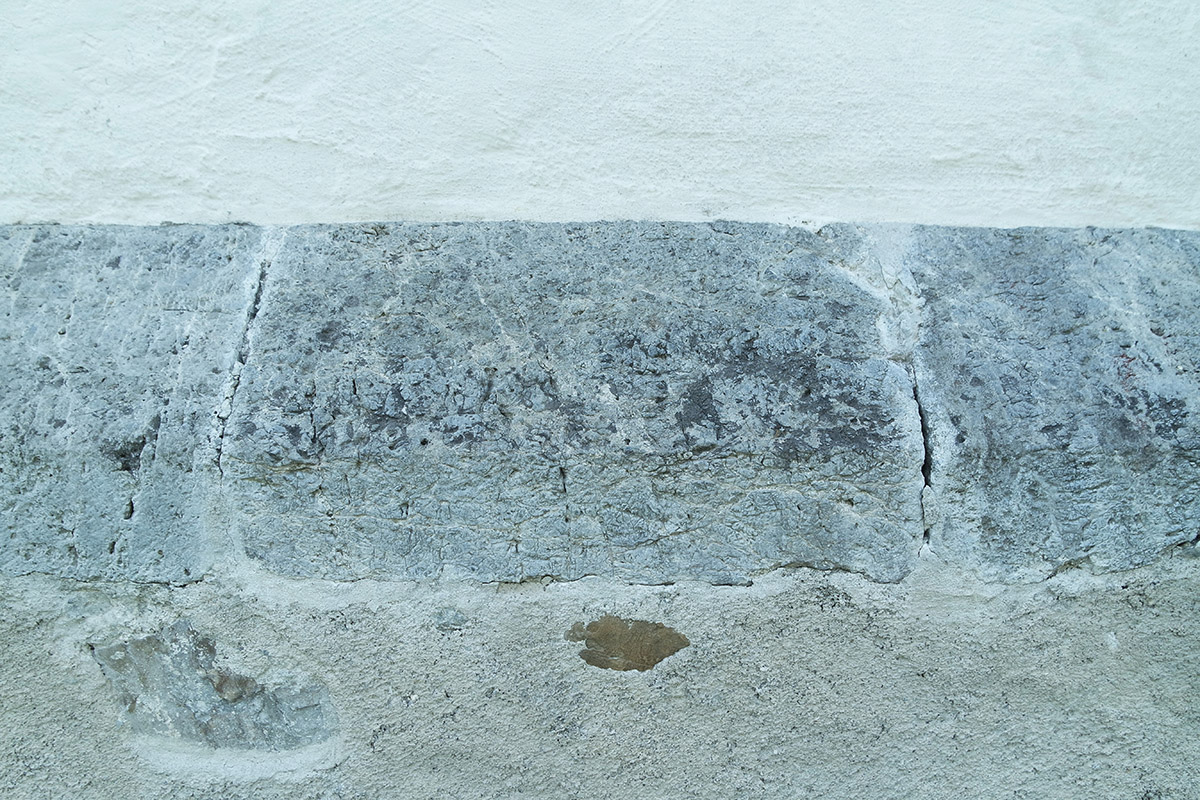 Processed dolomitic building stones at the base of the external facade.